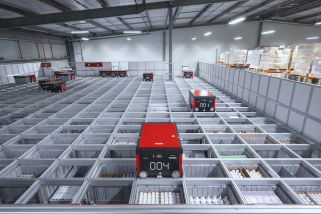 The new AutoStore system comprises approximately 6,500 bins arranged in a high-density grid, servedby 13 autonomous robots.