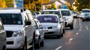 Vehicles queuing on a suburban street.